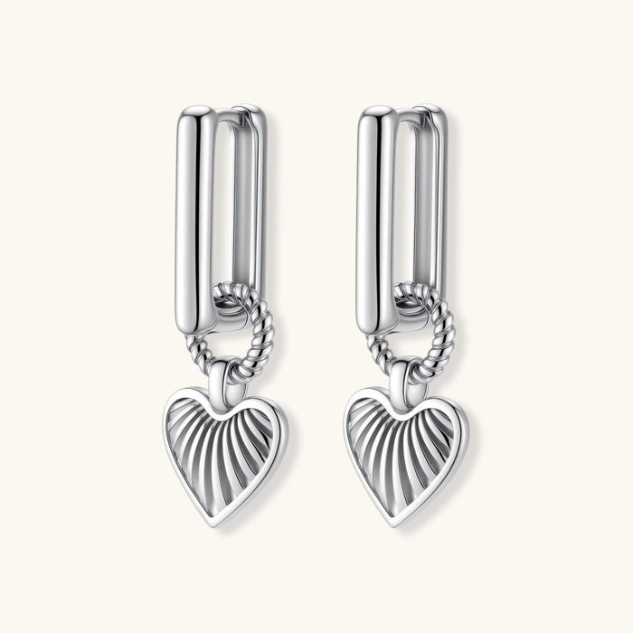 Platinum-plated 925 sterling silver rectangular hoop earrings with twisted ring connector and ribbed heart charm pendant.