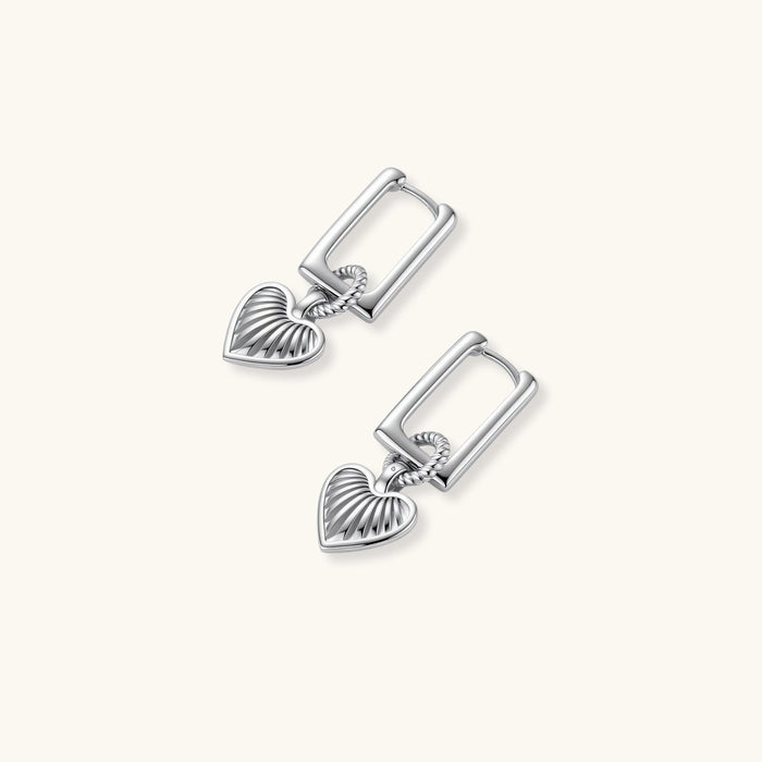 Platinum-plated 925 sterling silver rectangular hoop earrings with twisted ring connector and ribbed heart charm pendant.