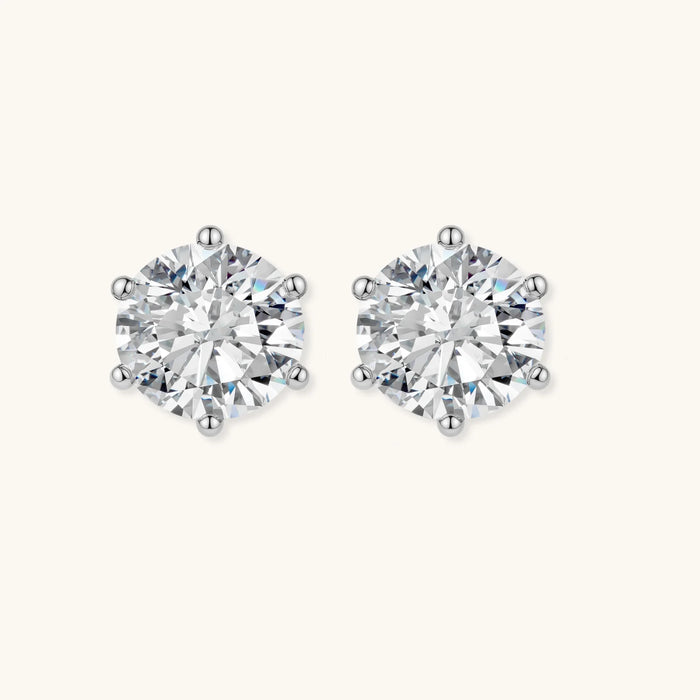 Close-up of round brilliant-cut moissanite stud earrings in 6-prong sterling silver settings showing exceptional sparkle