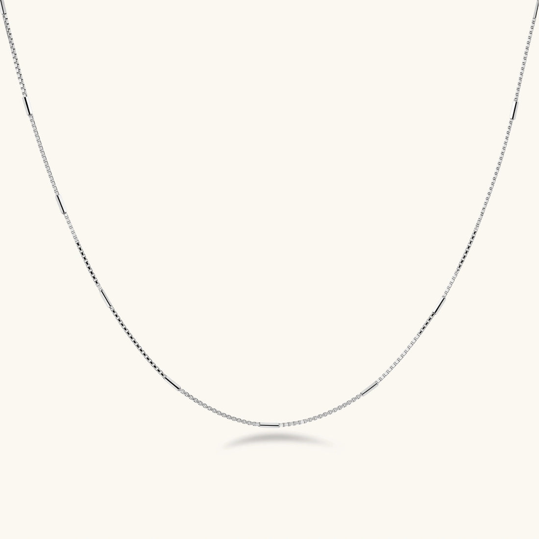 Delicate platinum-plated sterling silver necklace with alternating textured cubic links and smooth chain sections.