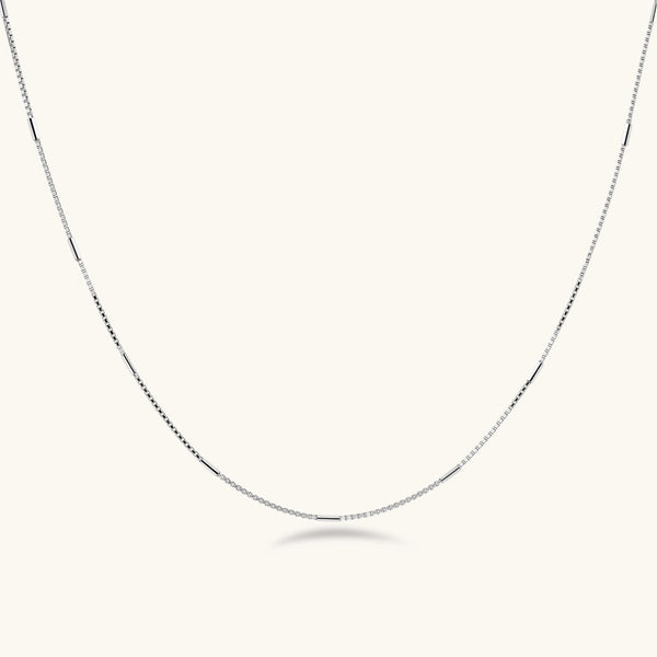 Delicate platinum-plated sterling silver necklace with alternating textured cubic links and smooth chain sections.